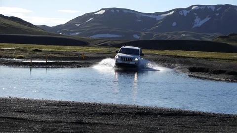 Fixed shot of a car crossing a ford near Landmannalaugar, in Iceland Stock Footage 71278153