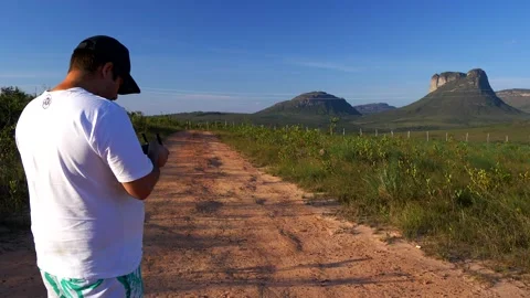 Fixed shot, a man piloting a drone near the Morrao, vale do Capao, bahia brazil Stock Footage 205125701