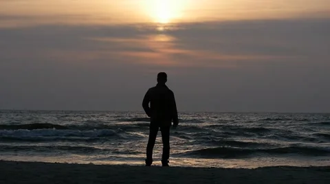 Fixed static silhouette of man at evening sea shore before sunset Stock Footage 47440262