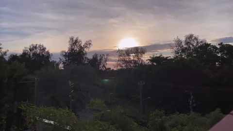 Fixed Time-Lapse Shot of a Tropical Sunrise Behind Trees Stock Footage 342016829