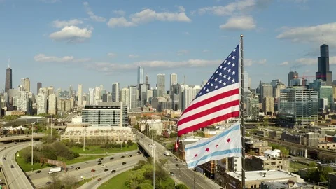 Fixed View of American and Chicago Flags Waving in Wind with City Skyline [4K] Video stock 107501389