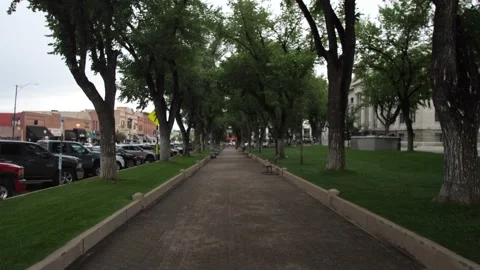 Fixed view of an empty walk way with trees next to the Prescott Courthouse. Stock Footage 160760110