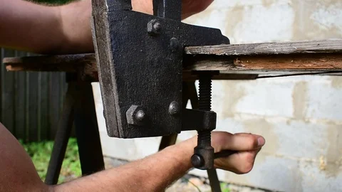 Fixes bench vise to the table Stock Footage 116543506