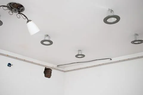 Fixing a baguette for a stretch ceiling to the wall Stock Photos