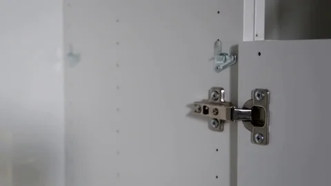 Fixing a cabinet hinge Stock Footage 79682088