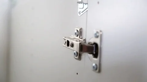 Fixing a cabinet hinge Stock Footage 79682096