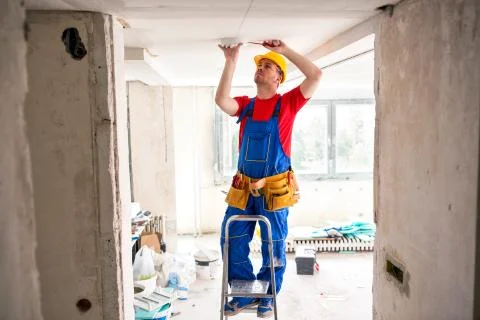 Fixing of ceiling light with screwdriver Stock Photos