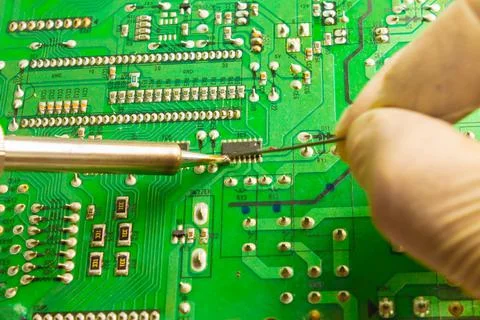 Fixing the chip with a soldering iron using tin solder Stock Photos