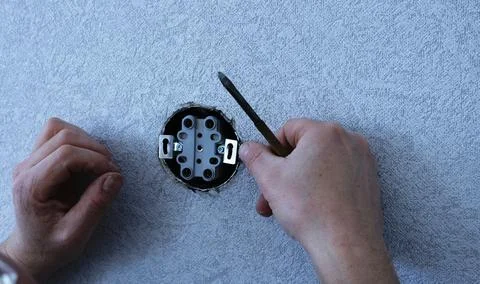 Fixing a double socket in a round wall niche Stock Photos