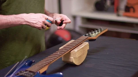Fixing an electric guitar, slow motion close up Видео 113064609