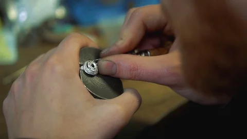 Fixing the gems in a ring with a tool for the process of inlay Stock-Footage 73553358