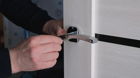 Fixing the handle on the light door close-up Stock Photos