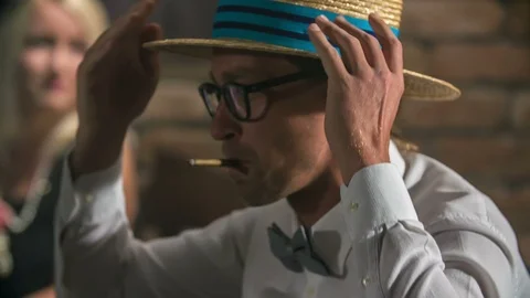 Fixing his straw hat and smoking a joint Stock Footage 112196441