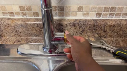 Fixing a kitchen faucet Stock Footage 220087999