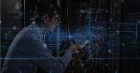 Fixing Korean tech checking rack cables in server room, holding phone, in light Foto stock