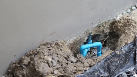 Fixing leaking water pipe underground the house Stock Photos