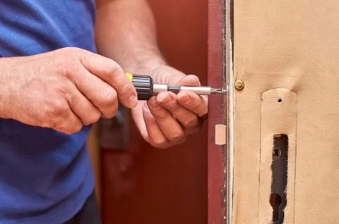 Fixing a lock in old door Photos