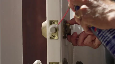 Fixing - lubricating home door lock deadbolt lock Stock Footage 285463633