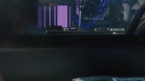 Fixing the motherboard inside the computer case during system assembly Stock Footage 328985778