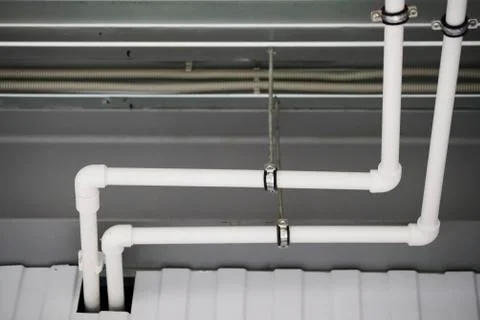 Fixing the pipes under the ceiling Stock Photos