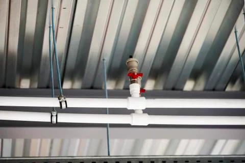 Fixing the pipes under the ceiling Stock Photos