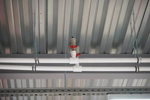 Fixing the pipes under the ceiling Stock Photos