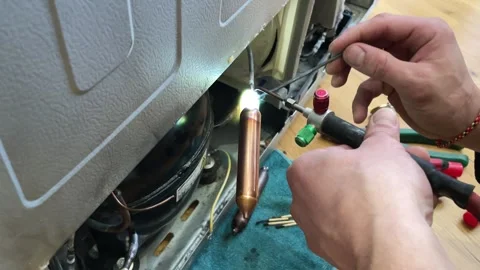 Fixing the refrigerator that not cooling enough by recharging Freon tube. Master Stock Footage 270278933