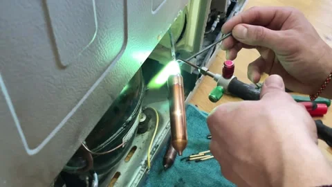 Fixing the refrigerator that not cooling enough by recharging Freon tube. Master Stock Footage 270476936