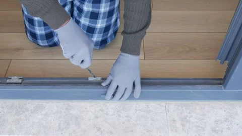 Fixing a sliding door in a home Stock Footage 341374033