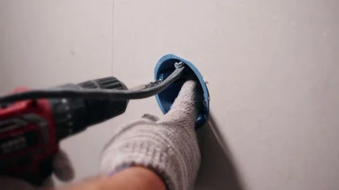 Fixing the socket or switch in the wall Stock Footage 200836548