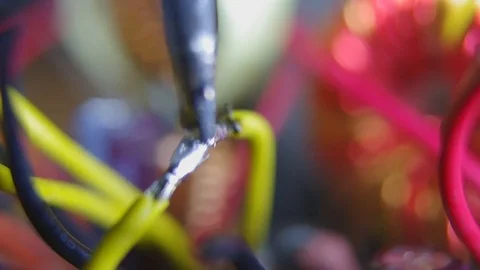 Fixing with the soldering iron of two yellow wires Stock Footage 81787128