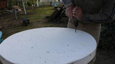 Fixing the table top with a screwdriver Stock Photos