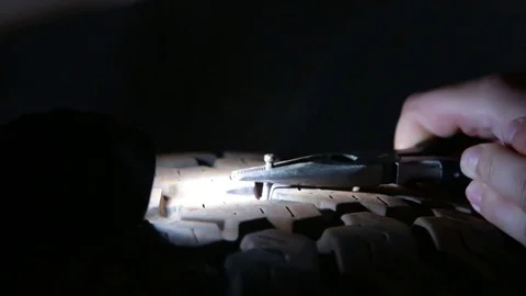 Fixing a tyre puncture by pulling out nail Stock Footage 70966673