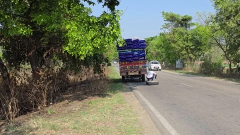 Fixing a Tyre Puncture on the Roadside in India Stock Footage 313571326