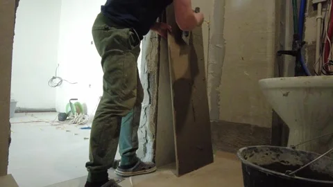 Fixing a wall with cement in a room during a home renovation project in an apart Stock Footage 332479778