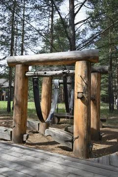 A fixture made of logs and straps for holding a horse during shoeing Stock Photos