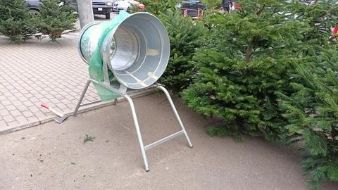 Fixture for wrapping Christmas trees in mesh fabric for sale to customer in Stock Photos