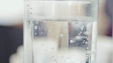 Fizzy Bubbles in a tall translucent glass of water or pop Stock-Footage 73056588
