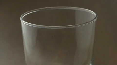 Fizzy cola flavored beverage flowing into clear glass forming frothy bubbles  Stock Footage 62794513