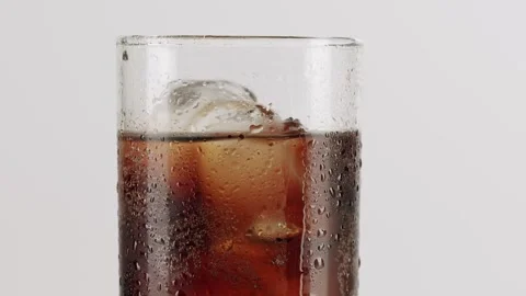 Fizzy cola with ice cubes in a glass on white background Stock Footage 342736581