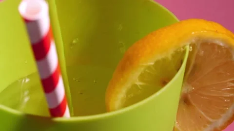 Fizzy cool drink with sliced lemon and drinking straw Stock Footage 217781203