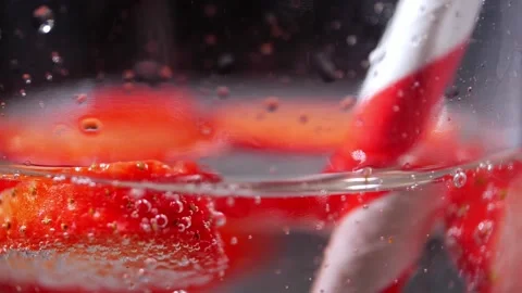 Fizzy cool drink with sliced strawberry macro close up Stock Footage 213637339