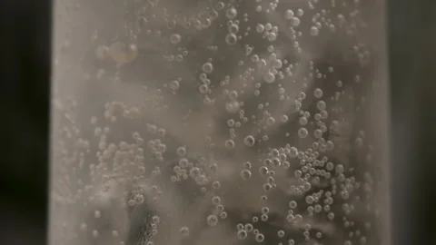 A Fizzy Drink Bubbles in a Glass of Ice Sitting on a Table Stock Footage 270406772