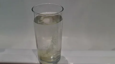 A fizzy drink in a glass. Effervescent tablet in a glass of water. Stock Footage 156703685