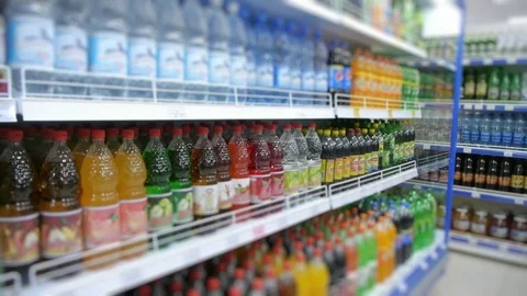 Fizzy drinks on the supermarket shelf, blurry Stock Footage 70706437