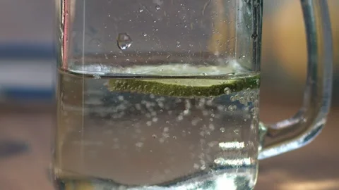 Fizzy soda drink with slice of lime served in glass drinking jar Stock Footage 266152123