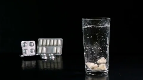 Fizzy tablet in a glass of water Stock Footage 74360488