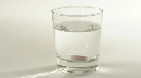 Fizzy vitamin tablet dissolving in water Stock Footage 21362688