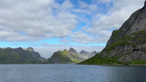 Fjord and mountains viewed from a moving boat near Reine village, Lofoten Island Video stock 332876204