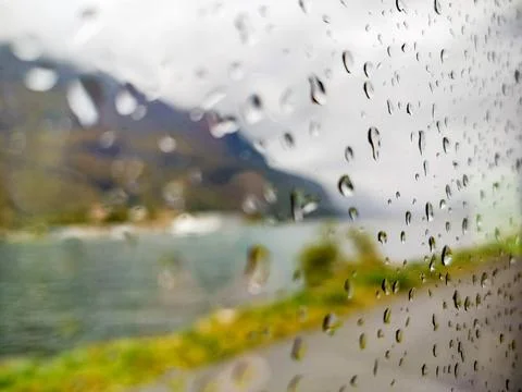 Fjord through raindrops on window Stock Photos